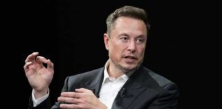 Musk Targets Lawmakers Elon Musk in a suit talking.