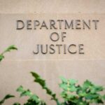 DOJ Spotlight Hits Democrat – What’s Buried Here? Sign displaying 'Department of Justice' on a stone wall
