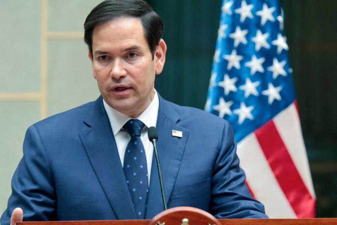 shutterstock_2581735273 Marco Rubio speaking at a podium with a U.S. flag in the background