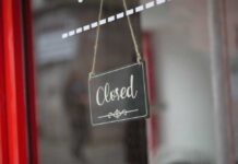 Cookie Darling SHUTS A closed sign hanging on a shop window
