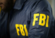 FBI agent in navy blue jacket.