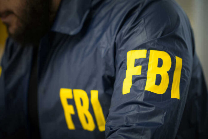 FBI agent in navy blue jacket.