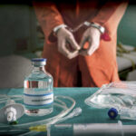 Governor: No Needle, No Innocence Handcuffed person behind Sodium Thiopental and medical equipment.
